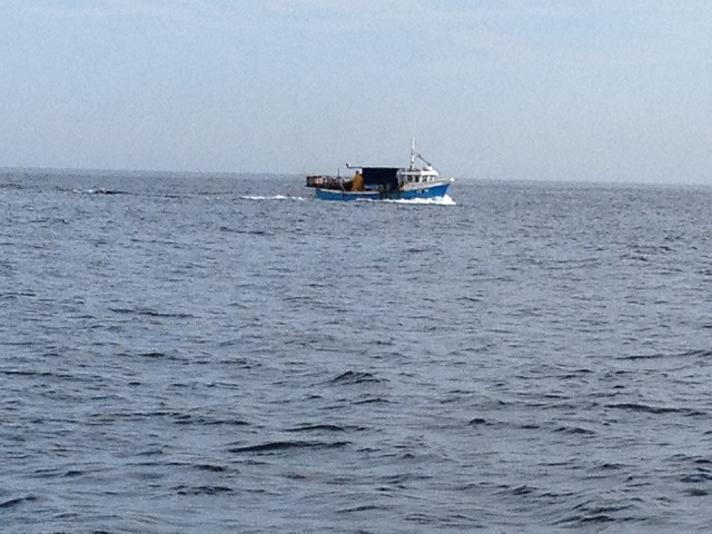 Photo of fishig vessel hauling up crab pots